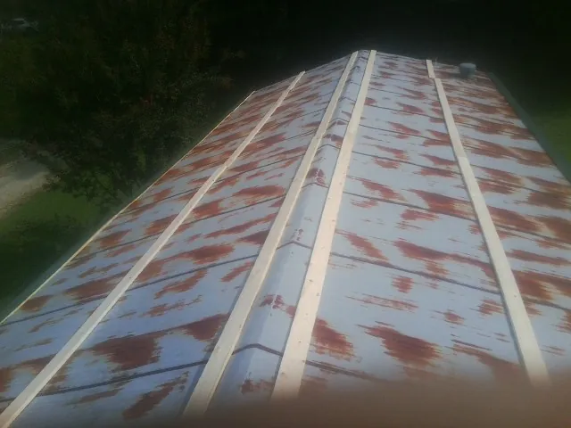 Rusted metal roof panels with new wood purlins before replacement — Storm Damage Roof Repair in Davy by Roofing Brothers